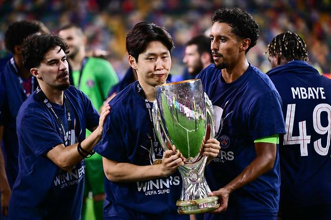 이강인(가운데)이 파리 생제르맹 동료들과 함께 14일 UEFA 수퍼컵 우승 트로피를 들고 기뻐하고 있다./AFP 연합뉴스