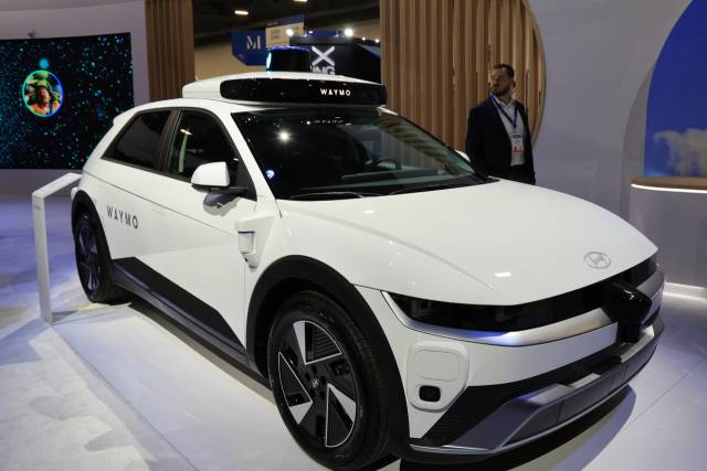 올 1월 미국 라스베이거스 컨벤션센터에서 열린 ‘CES 2025’의 웨이모 전시관에서 관람객이 웨이모 드라이버를 탑재한 현대 아이오닉5를 살펴보고 있다. 연합뉴스