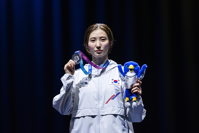 모별이가 지난달 19일(한국시간) 독일 에센의 메쎄 에센에서 벌어진 2025하게유니버시아드 4일째 펜싱 여자 플뢰레 개인전 결승을 마친 뒤 은메달을 들어 보이고 있다. 그는 3일 뒤 단체전 금메달을 수확하며 개인전 은메달의 아쉬움을 달랬다. 사진제공│스포노베이션 매니지먼트