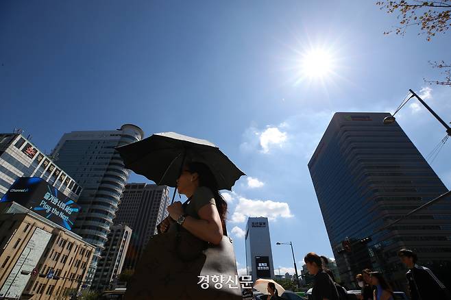 양산을 쓴 시민이 지난해 8월30일 서울 종로구 광화문광장 인근을 걸어가고 있다. 권도현 기자
