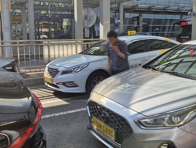 KTX울산역 택시 승강장에서 대기 중인 한 기사가 담배를 피우고 있다.
