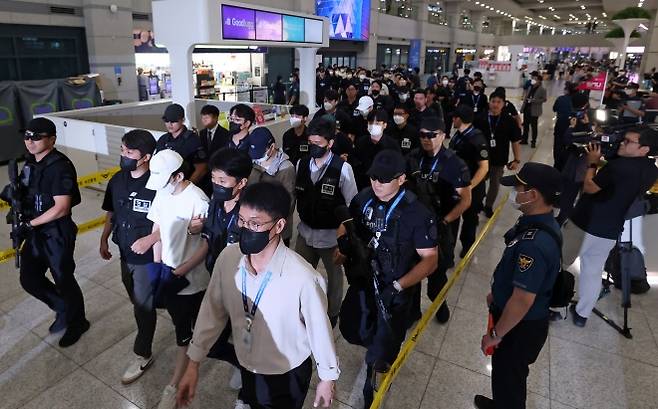 인천공항 통해 대거 송환되는 필리핀 한국인 범죄 피의자들 - 필리핀 현지에서 5조 원 규모의 불법 온라인 도박장을 운영하다 체포된 한국인 범죄조직 일당을 비롯한 필리핀 한국인 범죄 피의자 49명이 3일 오후 인천국제공항 1터미널을 통해 송환되고 있다. 전세기까지 동원된 이번 일시송환은 단일 국가에서 동시에 이뤄진 최대 규모 해외 검거 사범 송환으로, 송환된 피의자 중 인터폴 적색수배가 발부된 대상자만 45명에 달하며 이들을 대상으로 국내 수사기관에서 내려진 수배는 총 154건에 이른다. 2025.9.3 뉴스1