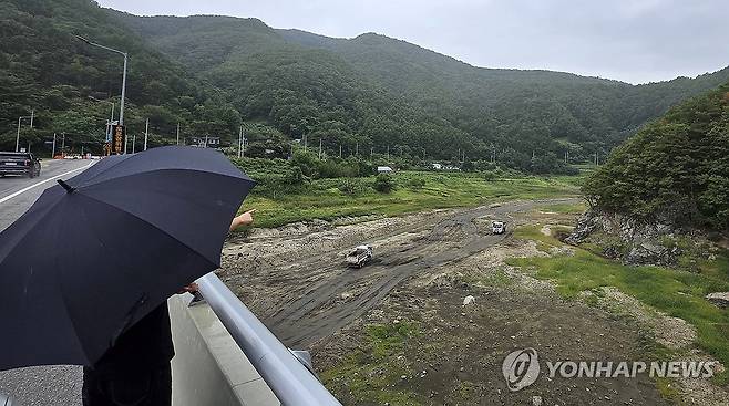 극한 가뭄 강릉에 찔끔 비 (강릉=연합뉴스) 유형재 기자 = 4일 강원 강릉시 주요 상수원인 오봉저수지 일원에 비가 내리고 있다. 맨바닥을 드러낸 저수지 상류에서 트럭들이 물길을 내는 작업을 하고 있다. 2025.9.4 yoo21@yna.co.kr