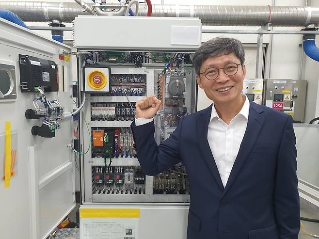 석종욱 GST 대표가 반도체 장비 칠러 앞에서 파이팅을 외치고 있다. 화성=윤현주 기자