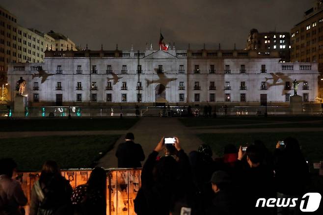 군부 쿠데타 발발 50주년을 맞은 11일(현지시간) 칠레 수도 산티아고의 대통령궁(라 모데나)에 군부가 폭격에 사용한 비행기가 투사된 모습이다. 2023.9.11. ⓒ AFP=뉴스1 ⓒ News1 김성식 기자