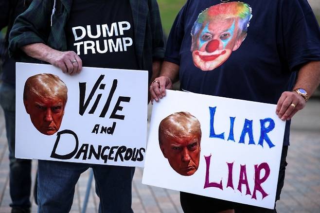 도널드 트럼프 미국 대통령의 영국 국빈 방문을 앞두고 16일(현지시간) 윈저에서 열린 시위 현장. 한 참가자는 가슴에 ‘덤프 트럼프’ 글귀가 적힌 티셔츠를 입고 “사악하고 위험하다”(Vile and Dangerous)라는 피켓을 들었다. 옆 참가자는 트럼프 얼굴을 삐에로로 합성한 그림이 새겨진 티셔츠를 입고 “거짓말쟁이”(Liar Liar)라는 피켓을 들고 항의에 동참했다. 로이터 연합뉴스