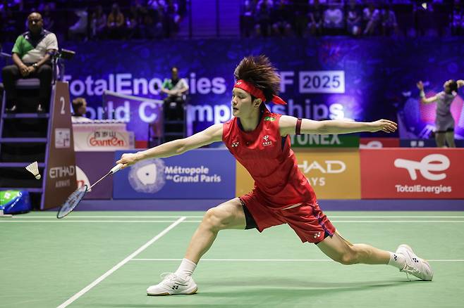 Wang Zhiyi in action on the badminton court.