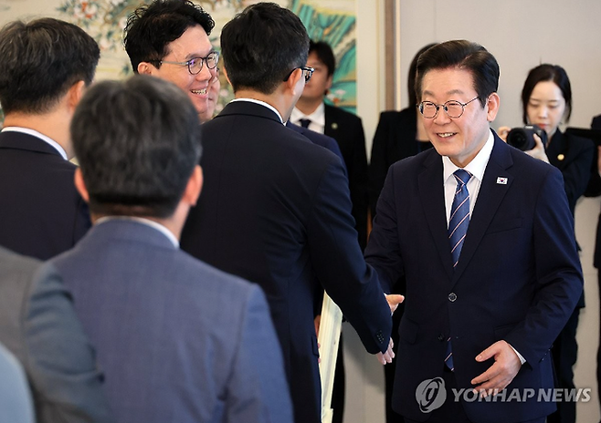 이재명 대통령이 18일 용산 대통령실에서 오찬 간담회에 참석한 증권사 리서치센터장들과 인사하고 있다. [사진 연합뉴스]