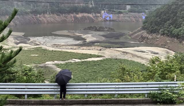폭우가 쏟아진 17일 한 강릉시민이 강원 강릉지역 생활용수를 공급하는 상수원 오봉저수지를 바라보고 있다. 연합뉴스