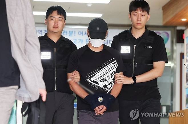 KT 무단 소액결제 사건의 피의자인 중국 국적 남성 A씨가 18일 구속 전 피의자 심문(영장실질심사)에 출석하기 위해 경기도 수원영통경찰서 유치장에서 나오고 있다. 연합뉴스