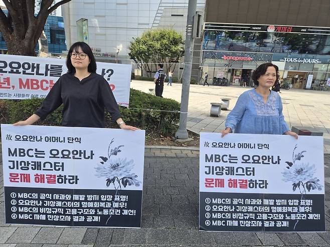 2025년 9월19일 서울 마포구 상암동 ‘고 오요안나 기상캐스터 분향소’ 맞은편에서 김용균재단 김예진 활동가(왼쪽)와 김미숙 재단 이사장이 팻말 시위를 하고 있다. 신다은 기자