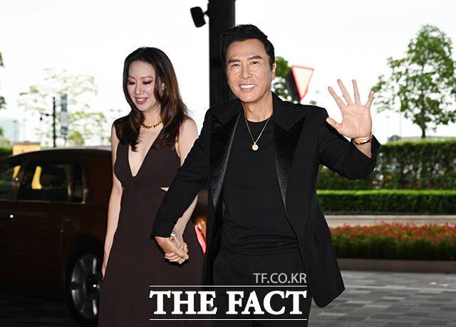 <더팩트>가 주최하고 팬앤스타와 더스퀘어이엔엠이 주관하는 '2025 더팩트 뮤직 어워즈(THE FACT MUSIC AWARDS, TMA)'가 20일 오후 '마카오 아웃도어 퍼포먼스 베뉴'에서 열린 가운데 세계적인 액션배우 겸 감독 견자단(오른쪽)과 아내 씨실리아 웡(Cecilia wang)이 손을 흔들고 있다. /마카오=박헌우 기자