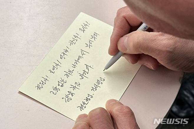 지난해 3월 '개구리 소년' 33주기 추모제가 열린 대구 달서구 와룡산에서 한 시민이 소년들에게 편지를 쓰는 모습./사진=뉴시스