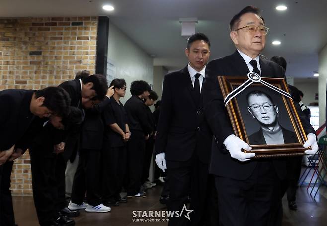 (서울=뉴스1) 김명섭 기자 = 28일 서울 영등포구 여의도 KBS 개그콘서트 녹화 세트장에서 열린 코미디언 고(故) 전유성의 노제에서 영정이 운구되고 있다.  2025.9.28/뉴스1  Copyright (C) 뉴스1. All rights reserved. 무단 전재 및 재배포,  AI학습 이용 금지. /사진=(서울=뉴스1) 김명섭 기자