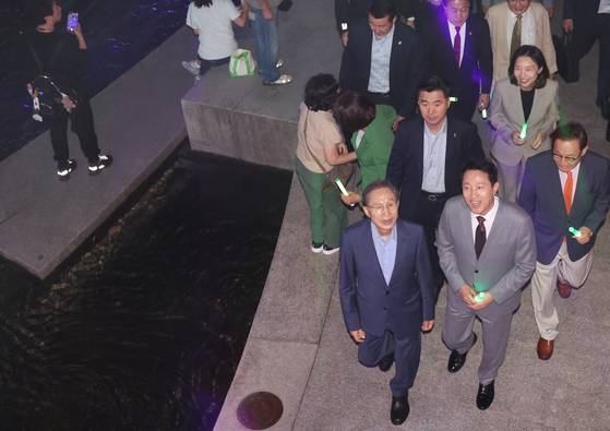 1일 청계천 복원 20주년 행사를 마친 이명박 전 대통령(앞줄 왼쪽)과 오세훈 시장이 내빈들과 함께 청계천 변을 산책하고 있다. [연합뉴스]