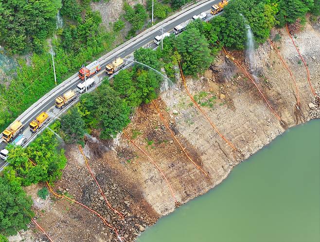 지난 9월 9일 강원 강릉시 오봉저수지에서 육·해·공군과 소방, 전국 지자체 및 기관이 지원한 살수차들이 수위를 높이고자 물을 쏟아붓고 있다. [연합]