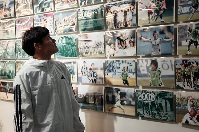 최철순이 구단 역사를 기록한 사진들을 보며 생각에 잠겨 있다. 전북 현대 제공