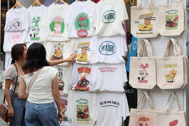 외국인 관광객들이 한글날인 9일 서울 종로구 삼청동 골목에서 한국어가 적힌 티셔츠를 살펴보고 있다. 연합뉴스