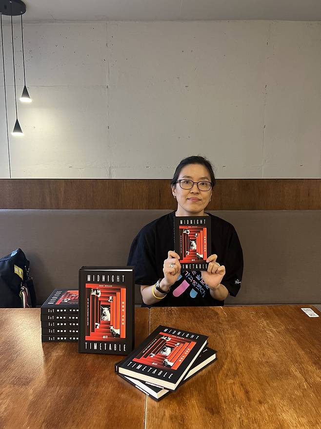 정보라 작가가 최근 미국과 영국에서 출간한 ‘한밤의 시간표’ 영역본을 들어보이고 있다.  [퍼플레인 제공]