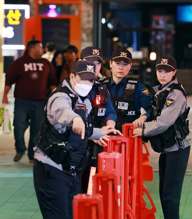 24일 서울 용산구 이태원 세계음식문화의 거리 일대에서 서울경찰 기동순찰대원들이 거리에 설치된 이동식 중앙 분리대를 점검하고 있다.(사진=연합뉴스)