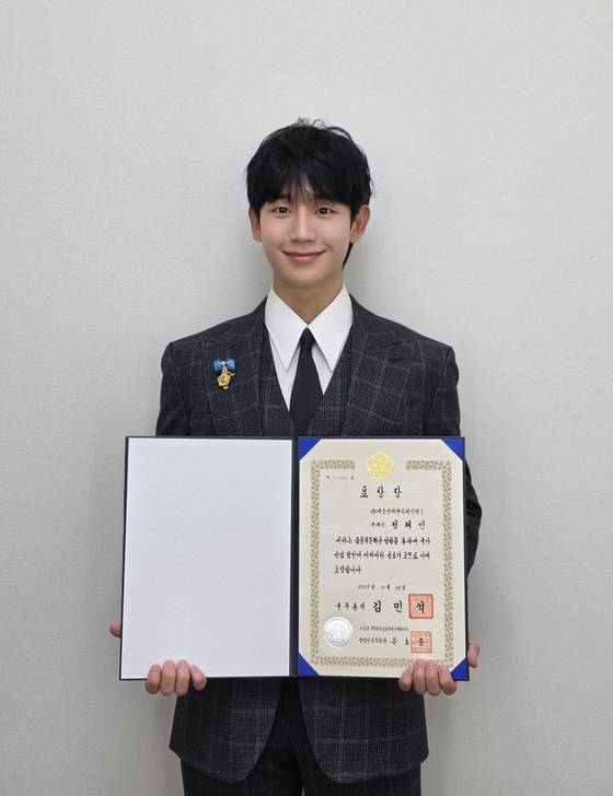 Actor Jung Hae-in poses for a photo after receiving the Prime Minister’s Commendation at the 10th Financial Day ceremony held at the FKI Tower in Yeouido, Seoul, on Oct. 28. [FNC ENTERTAINMENT]