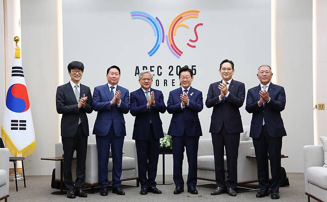 South Korean President Lee Jae-myung takes photo with business leaders ahead of his meeting with Nvidia CEO Jensen Huang at the HICO convention center, the venue for the APEC summit, in Gyeongju on Friday. From left are Naver founder Lee Hae-jin, SK Group Chairman Chey Tae-won, Jensen Huang, President Lee, Samsung Electronics Chair Lee Jae-yong, and Hyundai Motor Executive Chair Chung Euisun. (Yonhap)