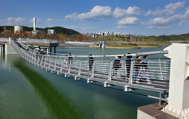 지난 1일 대전 서구 도안동 갑천생태호수공원을 찾은 시민들이 호수 위에 놓인 출렁다리를 건너고 있다. /신현종 기자