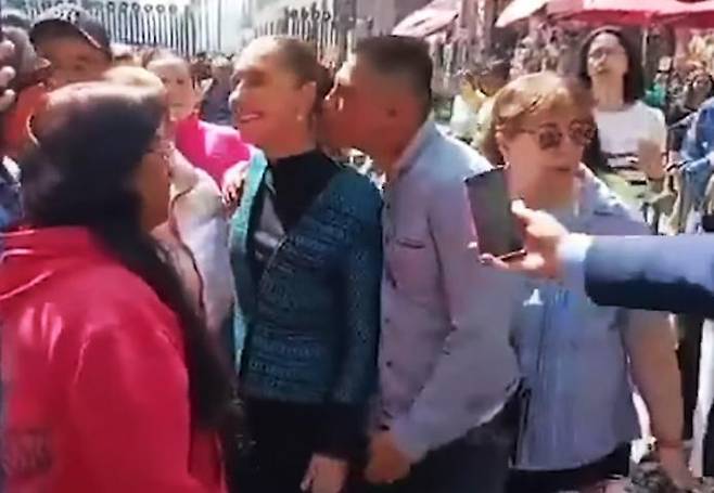 A screenshot from a YouTube video shows an intoxicated man sexually harassing Mexican President Claudia Sheinbaum on a street in Mexico City on November 4 (local time)