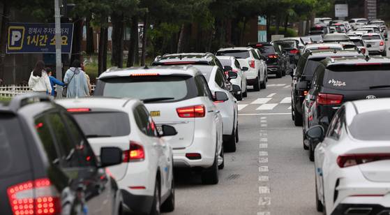 Cars are in line to enter Seoul Grand Park in Gwacheon, Gyeonggi, on May 5. Most of them are either white- or black-colored cars. [YONHAP]