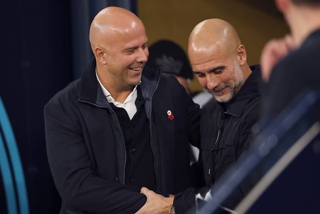펩 과르디올라 맨체스터 시티 감독이 10일(한국시간) 영국 맨체스터 에티하드 스타디움에서 열린 2025~26 잉글랜드 프리미어리그(EPL) 11라운드 리버풀과의 홈 경기 전에 아르네 슬롯 감독과 대화하고 있다. EPA 연합뉴스