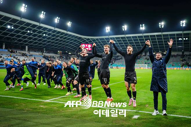 2026 북중미 월드컵 유럽 예선에서 슬로베니아를 꺾은 코소보 선수들이 원정팬들 앞에서 함께 기뻐하고 있다. 사진=AFPBBNews