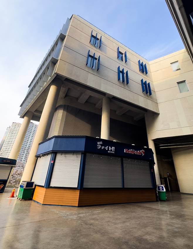 <yonhap photo-5624="">지난 29일 경남 창원시 마산회원구 창원NC파크에서 NC 다이노스와 LG 트윈스 경기 중 3루 방향 건물에 설치된 외장 마감 자재(알루미늄 소재 루버)가 낙하해 관람객을 덮쳤다. 이 사고로 A씨가 치료받다가 숨졌고, A씨 동생은 쇄골이 부러져 치료 중이다. 한국야구위원회(KBO)는 사고 이튿날 창원NC파크 경기를 취소했다. 또 희생자 추모와 경기장 안전 진단을 위해 4월 1∼3일 창원NC파크에서 열릴 예정이던 NC와 SSG 랜더스 3연전은 연기됐다. 사진은 31일 창원NC파크 마감 자재가 낙하한 건물(상단 가운데). 2025.3.31 [연합뉴스]</yonhap>