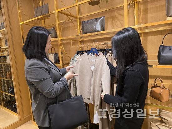 ▲ 19일 롯데백화점 울산점에서 소비자가 한 명품 매장에서 의류를 보고 있다.
