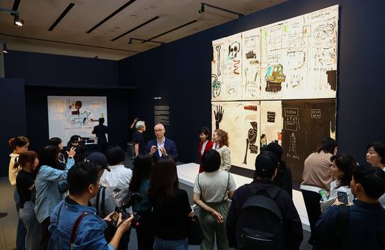 서울 동대문디자인플라자(DDP)에서 열리고 있는 바스키아 특별전에 걸린 대작 '살과 영'(1983)을 설명하는 큐레이터 디터 부흐하르트. 김종호 기자