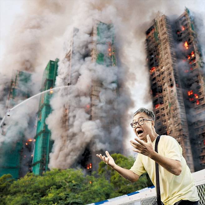 로이터 연합뉴스“아내가 갇혀 있어요” 홍콩 고층 아파트 화재로 최소 14명 사망 - 26일 홍콩 타이포 지역의 고층 아파트 단지 ‘왕푹코트’에서 발생한 화재로 건물 여러 채가 화염에 휩싸인 현장에서 대피한 주민이 “아내가 갇혀 있다”며 울부짖고 있다. 이 불로 소방관을 포함 최소 14명이 숨지고 16명이 중상을 입었다.