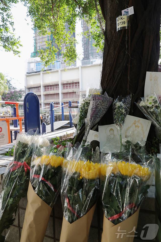 29일(현지시간) 홍콩 북부 타이포의 '왕 푹 코트'(Wang Fuk Court) 아파트 단지 인근에 희생자들을 추모하는 국화꽃이 놓여있다. 2025.11.29/뉴스1 ⓒ News1 권현진 기자