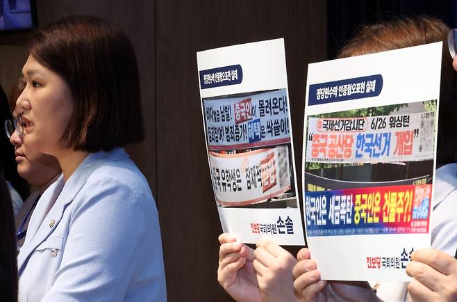 A South Korean lawmaker speaks at a press briefing at the National Assembly in Seoul in August while colleagues hold printed examples of political banners that target Chinese nationals with phrases such as “Chinese students are 100 percent potential spies” and “Chinese people are pouring in. They bring in crimes.” The event was held to call for legislation restricting racist and inflammatory content in political banners. (Newsis)