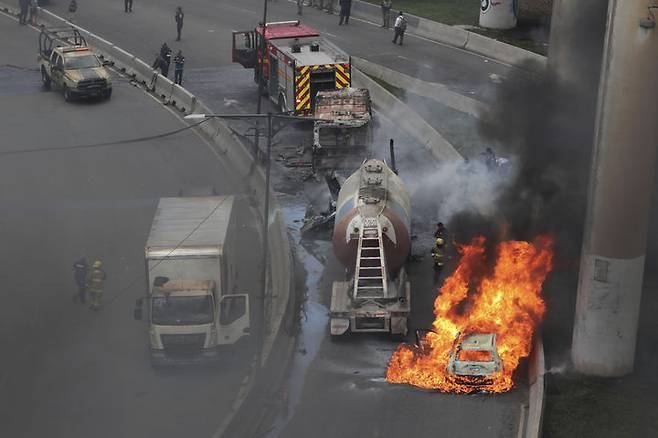 [멕시코시티=AP/뉴시스] 지난 9월 10일 멕시코 수도 멕시코시티의 한 고속도로에서 가스 운반 트럭(가스 탱커)이 폭발해 주변에 있던 자동차 한 대가 불길에 휩싸여 있다.  이 폭발로 차량 18대가 불에 타고 최소 57명이 부상했다.  최근 반정부 시위가 계속 중인 서부 미초아칸주에서는 12월 6일 코아후아야나 경찰서 앞에서 폭발물이 터져 2명이 죽고 여러 명이 부상당했다. 2025. 12. 07.