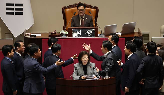 Lawmakers shout at each other as Rep. Na Kyung-won of the People Power Party continues her filibuster against a franchise business bill at the National Assembly in western Seoul on Dec. 9. [YONHAP]
