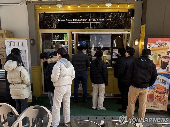 (서울=연합뉴스) 이진주 인턴기자 = 지난 3일 오후 종로구 커피 전문점 앞에서 사람들이 메뉴를 기다리고 있다. 2025.12.11