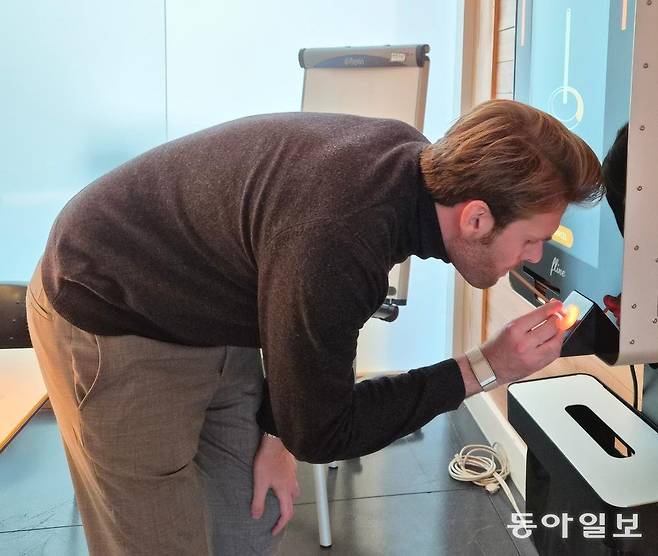 지난달 18일 오전 벨기에 와브르 ‘플라인’ 본사에서 아들랭 자크 드 딕스뮈드 대표가 음주 자가 측정기를 사용하고 있다. 빨대를 꽂고 10초간 숨을 불어넣으면 혈중알코올농도를 측정해 운전 가능 여부를 알려주는 이 기기는 브뤼셀 곳곳에 설치돼 음주운전에 경각심을 주고 있다. 와브르=서지원 기자 wish@donga.com