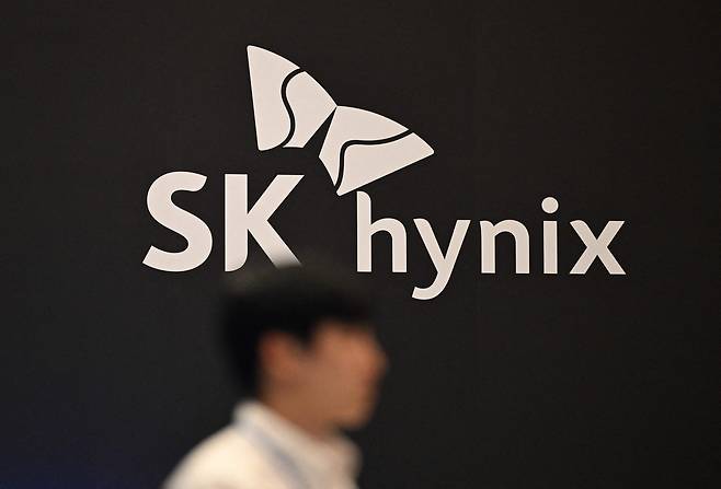 A man walks past the logo of SK hynix during a semiconductor exhibition at Coex in Gangnam District, southern Seoul on Oct. 24, 2024. [AFP/YONHAP]