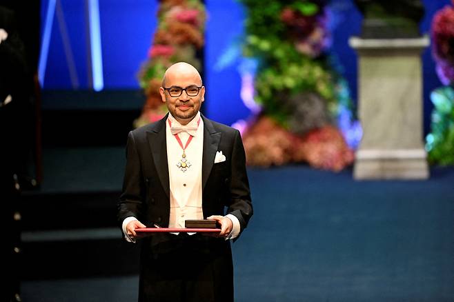 Nobel laureate in Chemistry Demis Hassabis receives his award from Sweden's King Carl Gustaf at the Nobel Prize ceremony at the Konserthuset in Stockholm on Dec. 10, 2024. The Royal Swedish Academy of Sciences decided to award the 2024 Nobel Prize in Chemistry to David Baker for computational protein design and to Demis Hassabis and John M. Jumper for protein structure prediction. [REUTERS/YONHAP]