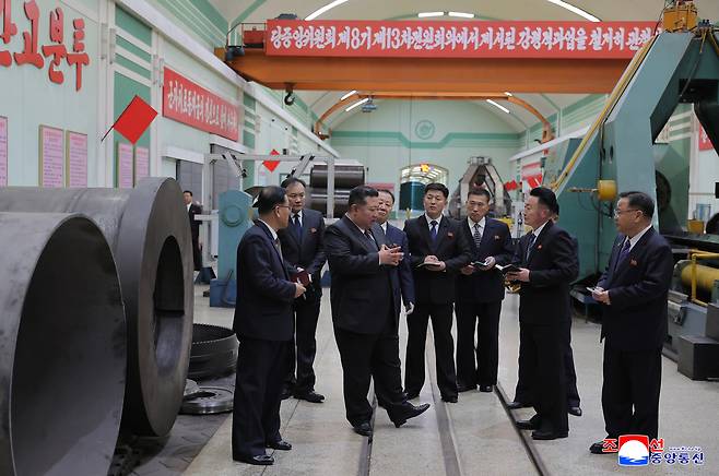 North Korean leader Kim Jong-un (center) inspects the production of missiles and artillery shells during his visit to major munitions industrial enterprises, in this undated photo released by North Korea's official Korean Central News Agency on Friday. (Yonhap)