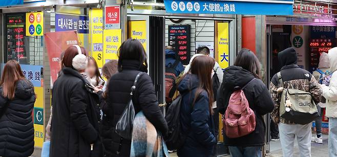 With two days left before foreign exchange trading closes for the year, the year-end closing exchange rate is increasingly likely to finish lower than last year’s level, though the annual average is expected to reach a record high. As of Dec. 26, the average exchange rate for the year, based on daytime trading closes, stood at 1,421.9 won, surpassing the 1998 average of 1,394.9 won during the Asian financial crisis. The photo shows a currency exchange booth in Myeong-dong, Jung District, Seoul, on Dec. 28. [YONHAP]