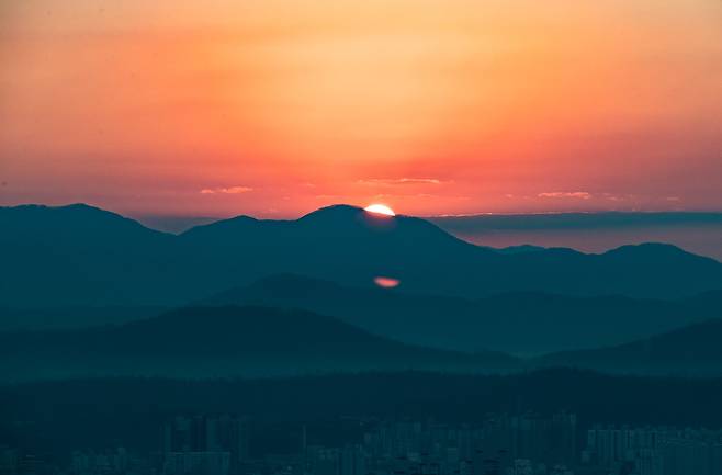 The sun rises over the mountains, seen from Mount Acha [YONHAP]