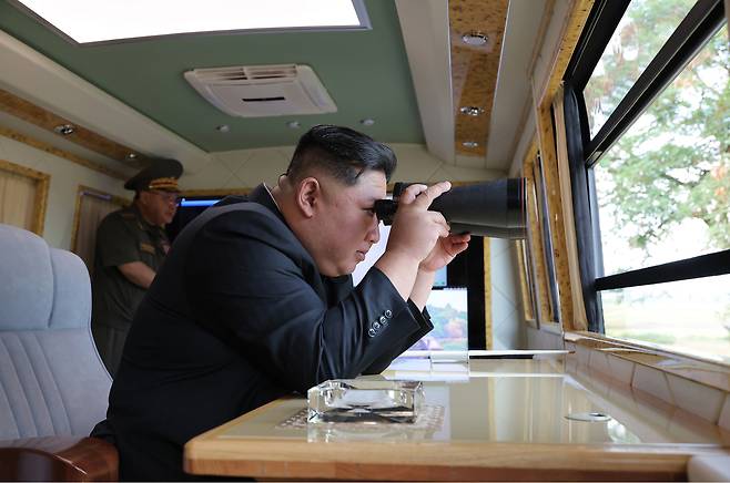 The North's leader Kim Jong-un inspects the armored defensive weapons institute and the electronic weapons institute under the Academy of Defence Sciences in this photo carried by North Korea's official Korean Central News Agency on Sept. 13. [KCNA]