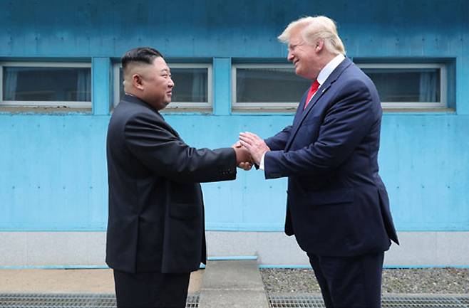 North Korean leader Kim Jong-un, left, and U.S. President Donald Trump shake hands during their summit at the truce village of Panmunjom near the inter-Korean border on July 1, 2019. [RODONG SINMUN]