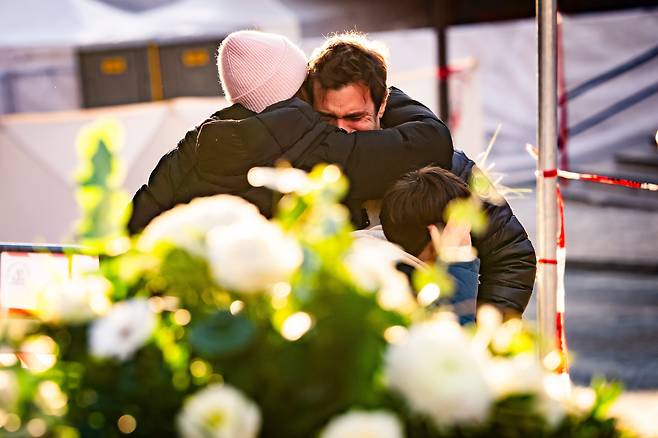 1일 화재 참사가 발생한 스위스 크랑 몬타나 르 컨스텔레이션 바 인근 현장에서 조문객들이 울고 있다. /연합뉴스