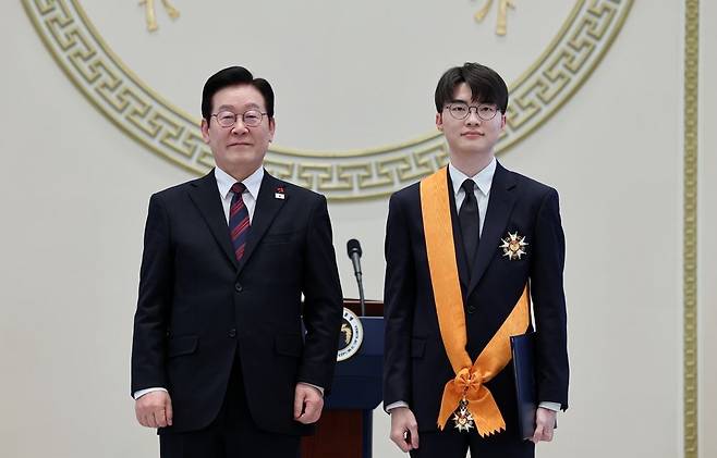 이재명 대통령이 2일 청와대 영빈관에서 열린 신년 인사회에서 프로게이머 ‘페이커’ 이상혁에게 체육훈장 청룡장을 수여한 뒤 기념촬영하고 있다. 연합